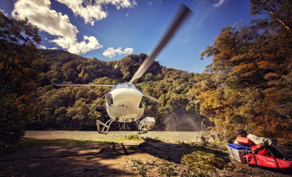 A helicopter takes off from a rafting pick up point at the Landsborough River in New Zealand